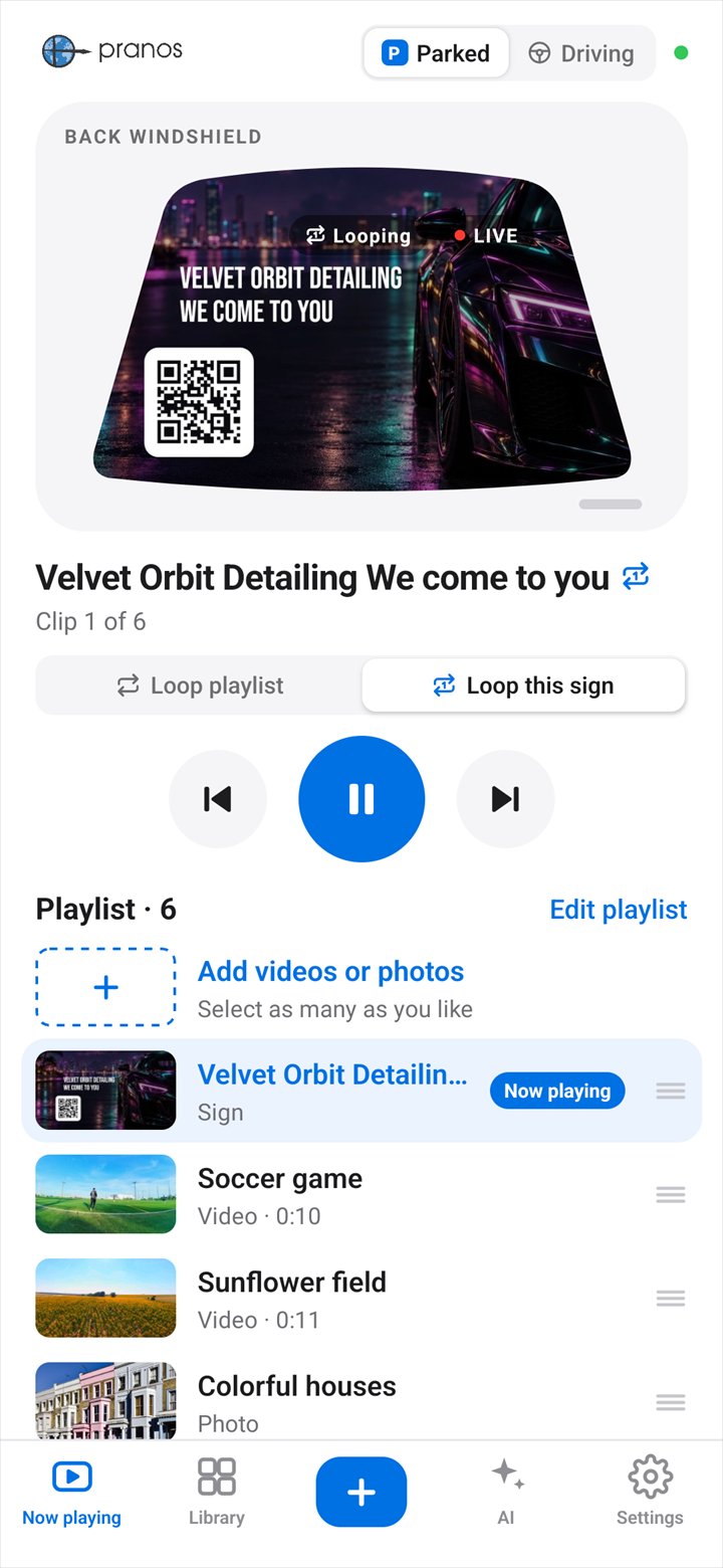 The Pranos app’s Now playing screen: Parked is selected, and the Velvet Orbit Detailing sign plays in the back windshield preview, with the play controls and the playlist below