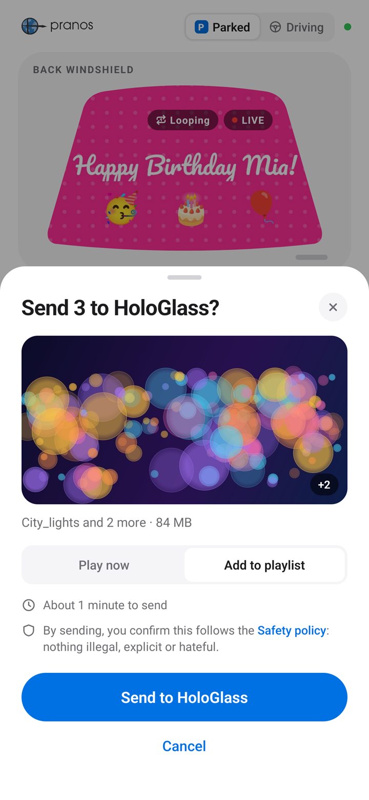 The Pranos app’s Send 3 to HoloGlass? sheet: a City lights video and 2 more, 84 MB, Add to playlist chosen, the Safety policy line and the Send to HoloGlass button