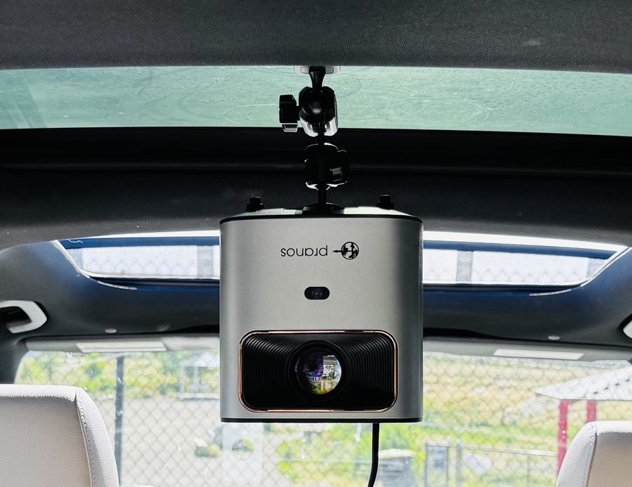 The HoloGlass unit hanging from its mount under a glass roof, above the back seats