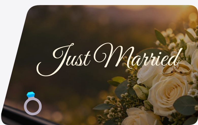 Just Married in cream script over white roses and two gold rings